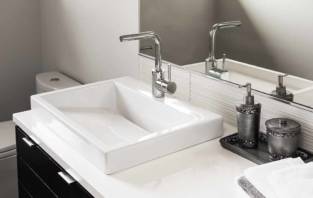 Bathroom detail in new luxury home: sink and faucet with view of